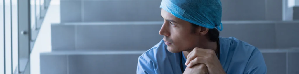 Photo of a medical professional sitting on o staircase